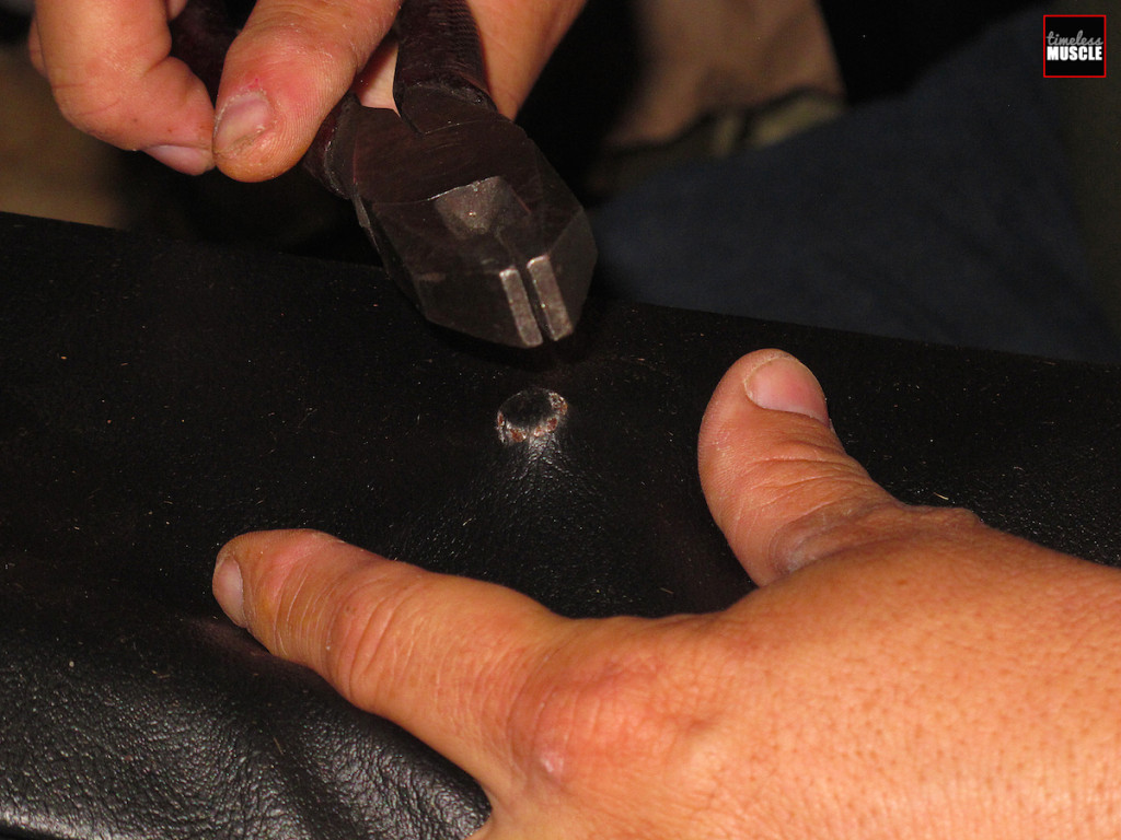 For the suds that hold the seat back to the bottom, just use a pair of heavy pliers or dikes like this and tap on the stud through the seat cover till the stud comes through the material.