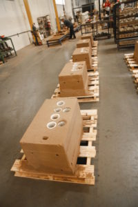 The top of the mold, called the “cope,” is lowered onto the drag after loading in the sand cores. Since metal is poured into the cope, it houses the sprue and risers. Sadly, the artfully sculpted sand molds and cores must be destroyed in order to punch out the cylinder head after the metal cools.